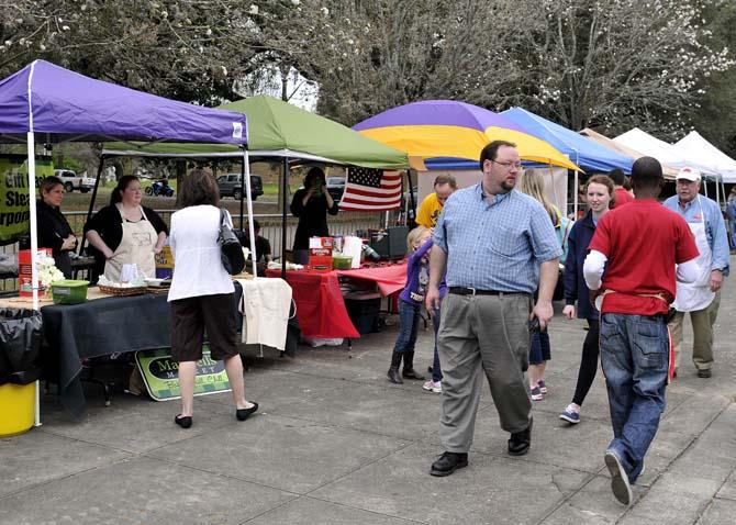 Visitors to the Chili Cookoff on LSU's campus walk past contender's tents Saturday, March 9, 2013.
 