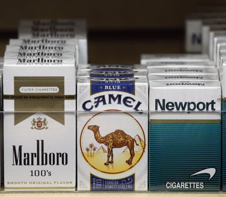 FILE - In this Nov. 12, 2012 file photo, packs of cigarettes are seen on display at a news stand in Chicago. On Friday, March 1, 2013, taxes on cigarettes sold in Cook County are going up by one dollar a pack. Anti-smoking activists say Chicago is now the second-most expensive place in the nation to buy cigarettes, behind New York City. (AP Photo/Charles Rex Arbogast, File)
 