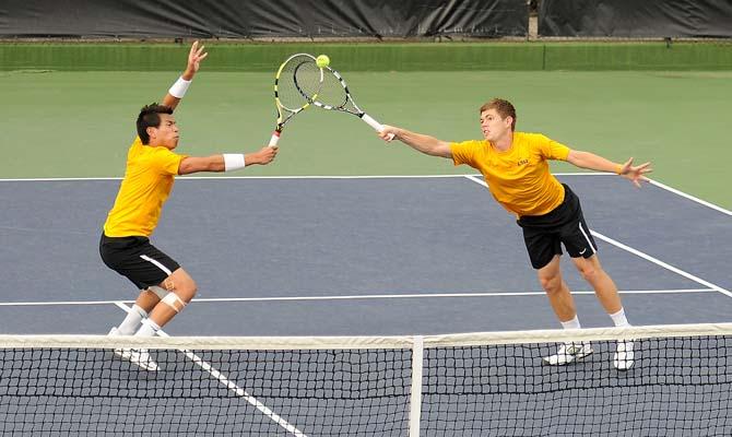 LSU senior Stefan Szacinski (left) and sophomore Chris Simpson (right) try for the ball Friday, March 8, 2013 during a doubles match at W.T. "Dub" Robinson Stadium.
 