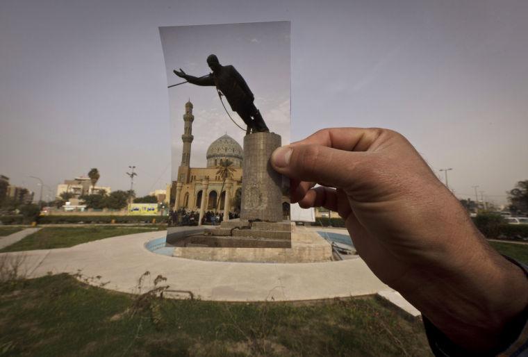 This Wednesday, March 13, 2013 photo shows a general view of Firdous Square at the site of an Associated Press photograph taken by Jerome Delay as the statue of Saddam Hussein is pulled down by U.S. forces and Iraqis on April 9, 2003. Ten years ago on live television, U.S. Marines memorably hauled down a Soviet-style statue of Saddam, symbolically ending his rule. Today, that pedestal in central Baghdad stands empty. Bent iron beams sprout from the top, and posters of anti-American Shiite cleric Muqtada al-Sadr in military fatigues are pasted on the sides.(AP Photo/Maya Alleruzzo)
 