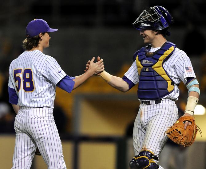 LSU senior southpaw Chris Cotton (58) celebrates with junior catcher Ty Ross (26) Wednesday, March 13, 2013 after the 9-3 victory against Nicholls State at Alex Box Stadim.
 