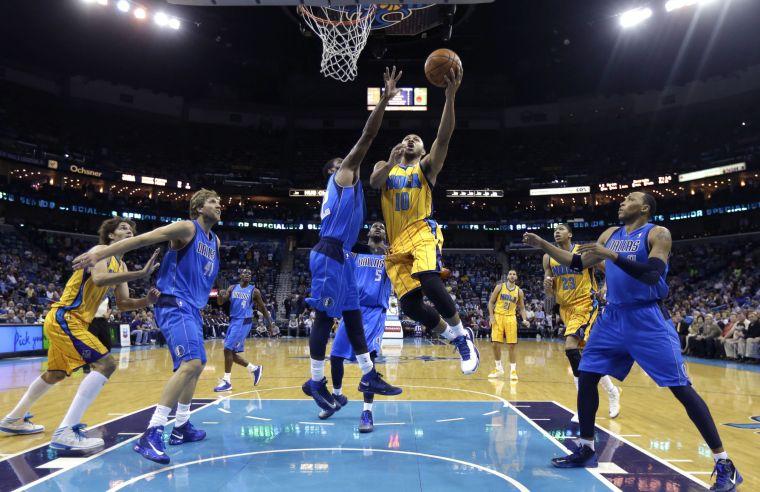 New Orleans Hornets guard Eric Gordon (10) drives to the basket against Dallas Mavericks' O.J. Mayo (32) in the first half of an NBA basketball game in New Orleans, Friday, Feb. 22, 2013. (AP Photo/Gerald Herbert)
 