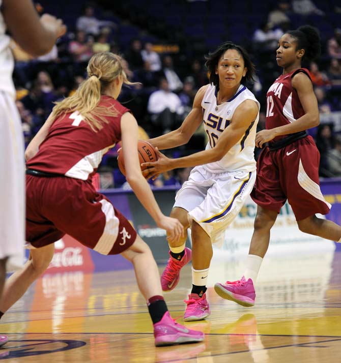 LSU senior guard Adrienne Webb (10) moves the ball past Alabama freshman guard Emily Davis (4) Thursday, Feb. 28, 2013 during the Tigers' 76-42 victory against the Crimson Tide.