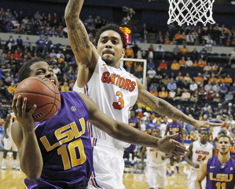 LSU guard Andre Stringer (10) heads to the hoop as Florida guard Mike Rosario (3) defends during the second half of an NCAA college basketball game at the Southeastern Conference tournament, Friday, March 15, 2013, in Nashville, Tenn. Florida won 80-58. (AP Photo/John Bazemore)
 