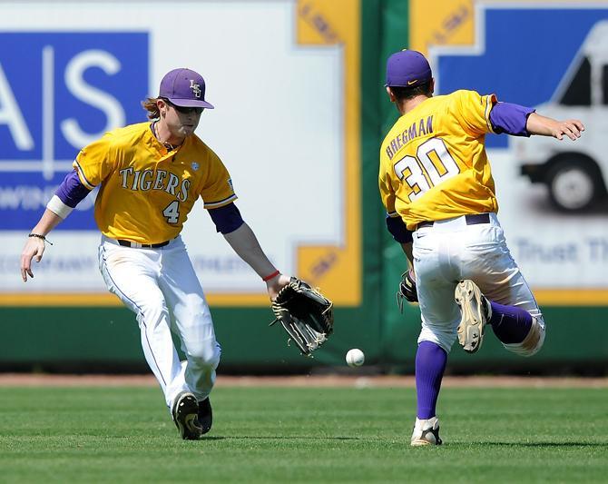 LSU senior right fielder Raph Rhymes (4) and freshman short stop Alex Bregman (30) miss a fly ball Sunday, March 24, 2013 during the 8-2 victory against Auburn at Alex Box Stadium.
 