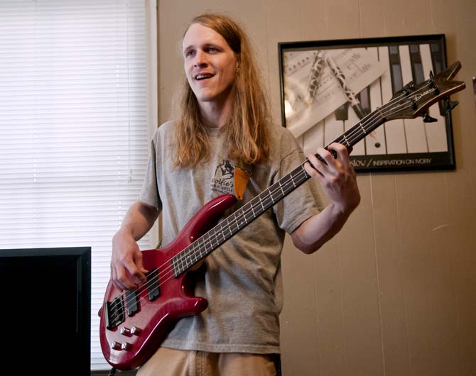 Corey Desselle, bassist in the band Trailer Hounds, smiles while jamming Sunday, March 24, 2013 during a band practice at a friend's apartment on E. State Street.
 