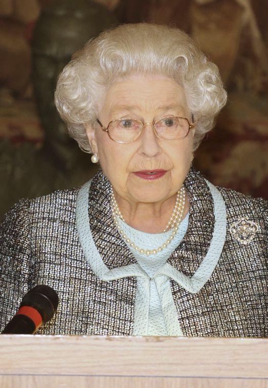 Britain's Queen Elizabeth II, Head of the Commonwealth signs the Commonwealth Charter at a reception at Marlborough House, London Monday March 11, 2013. The Charter is an historic document which brings together, for the first time in the associations 64-year history, key declarations on Commonwealth principles. (AP Photo/ Philip Toscano/PA) UNITED KINGDOM OUT NO SALES NO ARCHIVE
 