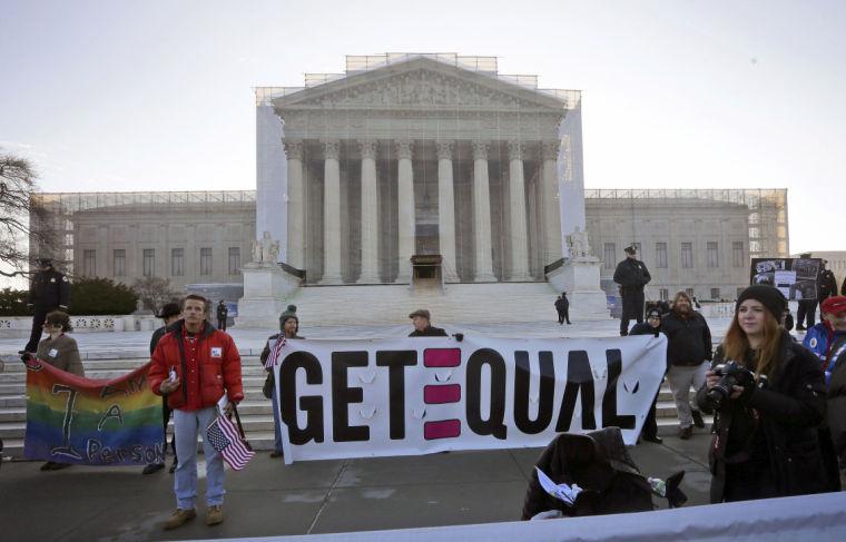 Demonstrators stand outside the Supreme Court in Washington, Tuesday, March 26, 2013, where the court will hear arguments on California&#8217;s voter approved ban on same-sex marriage, Proposition 8. (AP Photo/Pablo Martinez Monsivais)
 