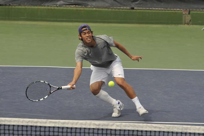 LSU freshman Tam Trinh hits the ball Sunday, March 17, 2013, during a doubles match against Michigan in W.T. "Dub" Robinson Stadium.
 