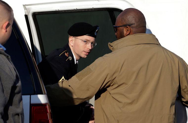 Army Pfc. Bradley Manning steps out of a security vehicle as he is escorted into a courthouse in Fort Meade, Md., Thursday, Nov. 29, 2012, for a pretrial hearing. Manning is charged with aiding the enemy by causing hundreds of thousands of classified documents to be published on the secret-sharing website WikiLeaks. (AP Photo/Patrick Semansky)
 