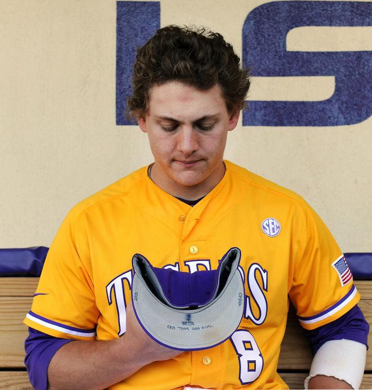 LSU senior first baseman Mason Katz holds his baseball cap inscribed with inspirational words and phrases, including his late grandfather&#8217;s nickname, &#8220;Hippo.&#8221;
 