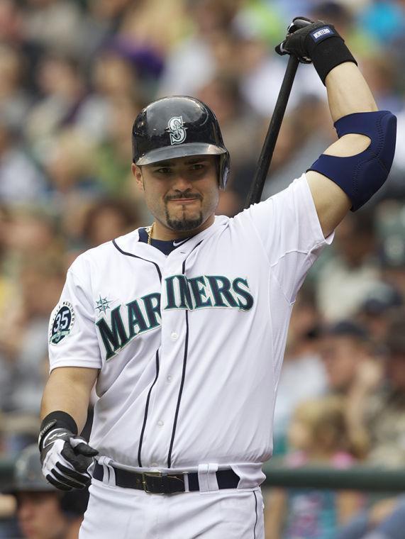 FILE - In this Sept. 9, 2012 file photo,&#160;Seattle Mariners' Jesus Montero warms up before an at-bat during a baseball game against the Oakland Athletics at Safeco Field in Seattle. Montero on Tuesday,n Feb. 12, 2013, again denied any involvement with a Florida-based anti-aging clinic under investigation by Major League Baseball. According to a published report last week, Montero was named in records belonging to Biogenesis of America LLC, the now-closed clinic in Coral Gables, Fla., that has purportedly been linked to performance-enhancing drugs. (AP Photo/Stephen Brashear, File)
 