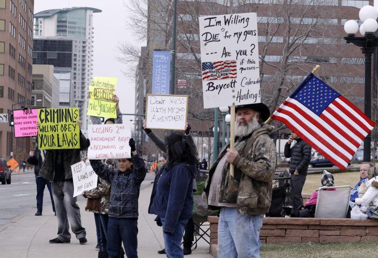 Protesters gather in front of the Capitol in Denver where State Senators are debating seven control bills on Friday, March 8, 2013. Colorado Democrats are on the cusp of passing gun control proposals in a state balancing a history of heartbreaking shootings with a Western heritage where gun ownership is treasured by many. (AP Photo/Ed Andrieski)
 