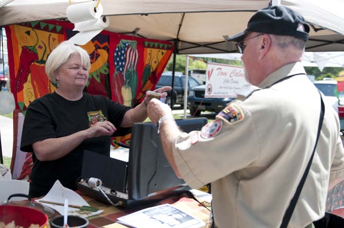 Wanda Dearing, left, of Newton, Miss., hands out samples of her Fire in the Hole chili at the Louisiana Chili Cook-Off Saturday, March 26, 2011, at the 4-H Barn near the Parker Coliseum.
 