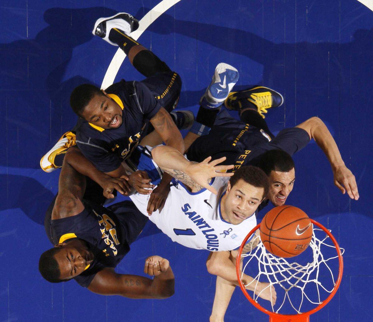 <p>Saint Louis forward Grandy Glaze (1) positions himself for a rebound against La Salle guard D.J. Peterson, right,, forward Jerrell Wright, lower left, and guard Sam Mills during the first half of an NCAA college basketball game, Saturday, March 9, 2013 in St. Louis. (AP Photo/St. Louis Post-Dispatch, Chris Lee)</p>