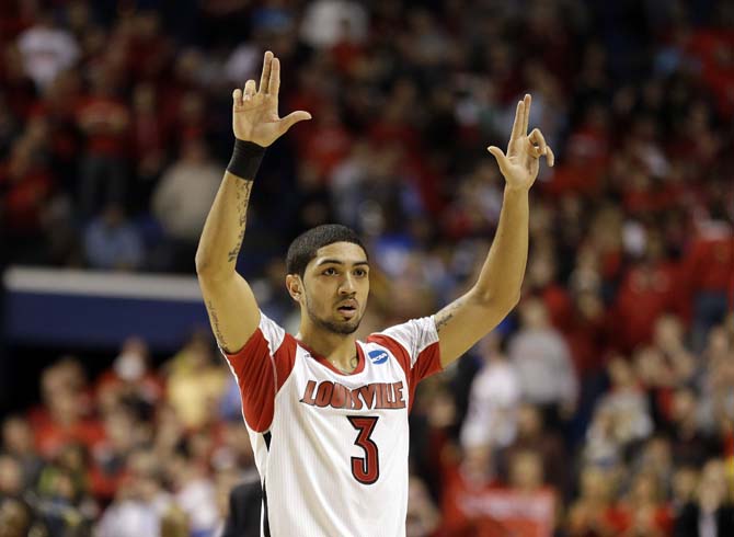 Louisville guard Peyton Siva (3) waves to the crowed after defeating Colorado State 82-56 in a third-round NCAA college basketball tournament game on Saturday, March 23, 2013, in Lexington, Ky. Louisville won 82-56. (AP Photo/John Bazemore)
 