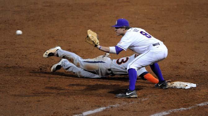 LSU senior first baseman Mason Katz leans over to make a catch Friday, March 22, 2013 during the Tigers' 9-4 victory against Auburn in Alex Box Stadium.
 