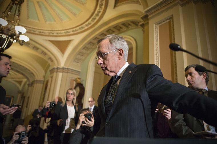 Senate Majority Leader Harry Reid, D-Nev., leaves a news conference after answering questions on the looming automatic spending cuts, at the Capitol in Washington, Tuesday, Feb. 26, 2013. Reid also responded to House Speaker John Boehner who used salty language earlier in the day to prod the Senate to act on legislation to replace the automatic spending cuts known as the sequester. (AP Photo/J. Scott Applewhite)
 