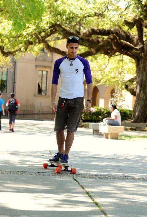 Photography sophomore Nick Martino rides his longboard on the sidewalk in the Quad on Tuesday.
 