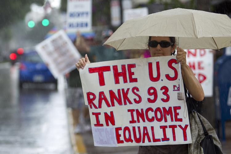 Nearly 200 Occupy Fort Lauderdale protesters march in the heavy rain in downtown Fort Lauderdale, Fla., Saturday, Oct. 29, 2011. Having started in New York, Occupy Wall Streets demonstrations now take place all across the United States, as protesters speak out against corporate greed and the gap between the rich and the poor. (AP Photo/J Pat Carter)
 