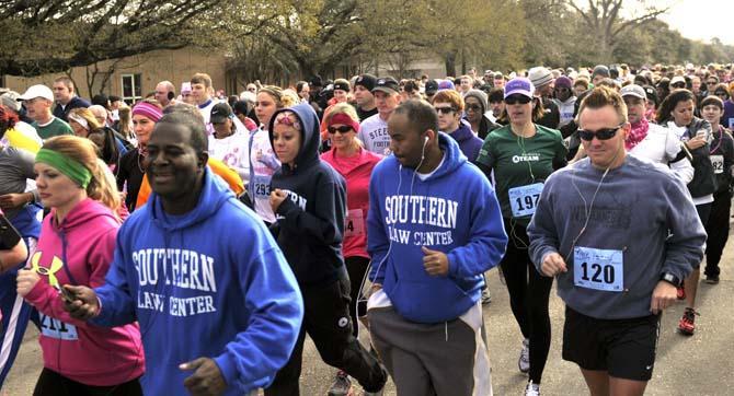 Runners take off from the starting line of the Susan G. Komen Baton Rouge Race for the Cure 5K race Saturday March 3, 2013 on Nicholson Extension near campus.
 