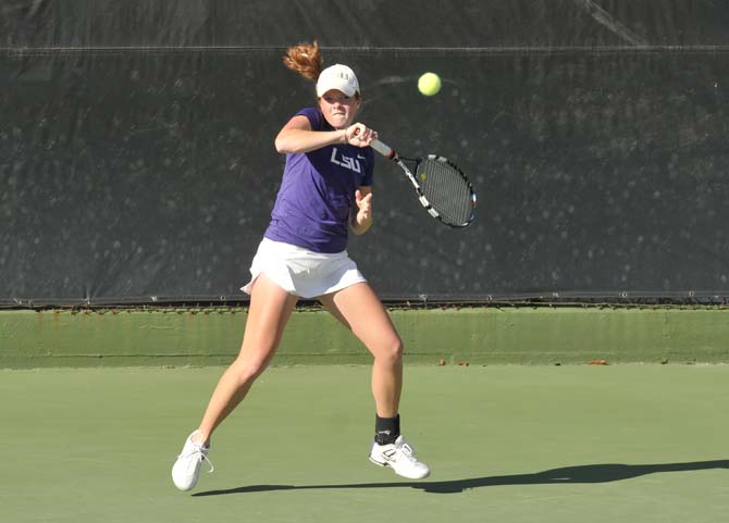 LSU freshman Caroline Hudson hits the ball Friday, March 15, 2013, during a match against Texas A&amp;M in W.T. "Dub" Robinson Stadium.
 