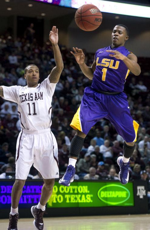 LSU's Anthony Hickey passes over Texas A&amp;M's J'Mychal Reese during the second half of an NCAA college basketball game in College Station, Texas on Wednesday, March 6, 2013. (AP Photo/Bryan-College Station Eagle, Stuart Villanueva)
 