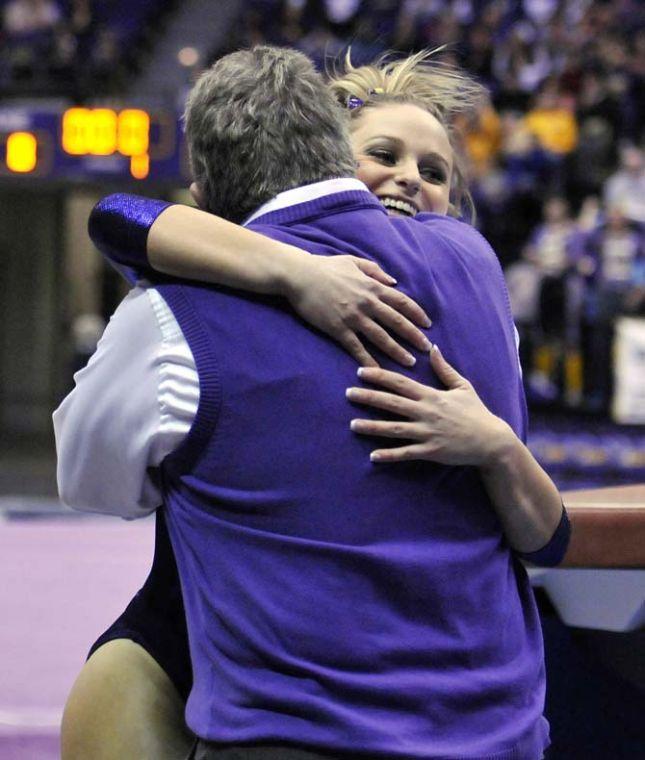 LSU sophomore all-around Jessie Jordan hugs assistant coach Bob Moore after her vault March 1, 2013 during the Tigers' 197-196 win against Georgia in the PMAC. Jordan scored a 9.90 on the vault.
 