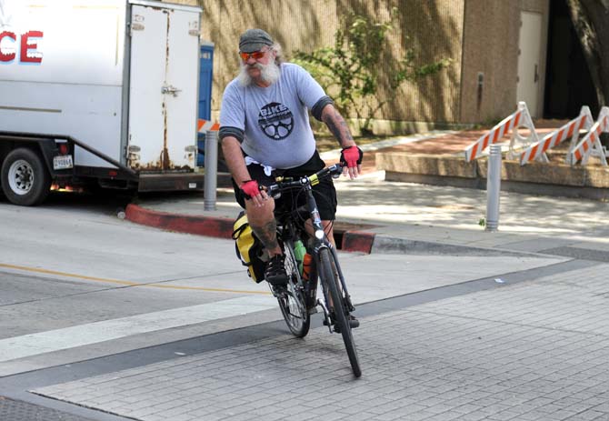 Mark E. Martin, Photographic Processing Archivist at LSU and leader of Bike Baton Rouge 2013, pulls into a valet bike parking area at the end of the route Sunday, April 7, 2013 at the North Boulevard Town Square in downtown Baton Rouge.
 