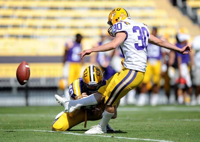 Freshman kicker Colby Delahoussaye (30) kicks an extra point after a score April 20, 2013 during the white squad's 37-0 victory against the purple squad in the National L Club Spring Game in Tiger Stadium.
 