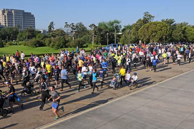 A crowd takes off Saturday, April 20, 2013, at the steps of the Louisiana State Capitol for Baton Rouge Run for Boston, a 2.62 mile run organized by several local running clubs to support victims of the Boston Marathon bombing.
 