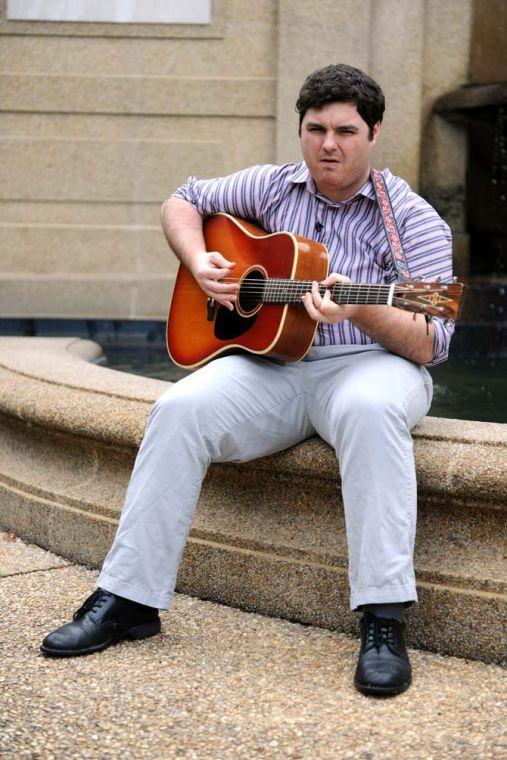 Matt Sigur, an acoustic guitar soloist, plays his guitar in front of the fountain in the quad Tuesday, April 30, 2013.
 