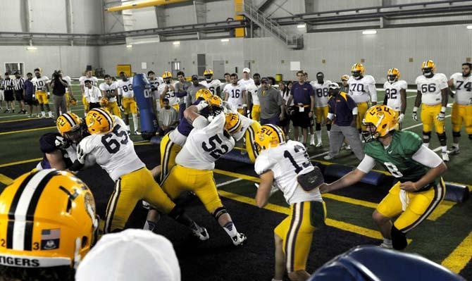 Senior quarterback Zach Mettenberger (8) passes the football to Sophomore wide receiver Chris LaBorde (13) as they run a practice play Tuesday, April 16, 2013.
 