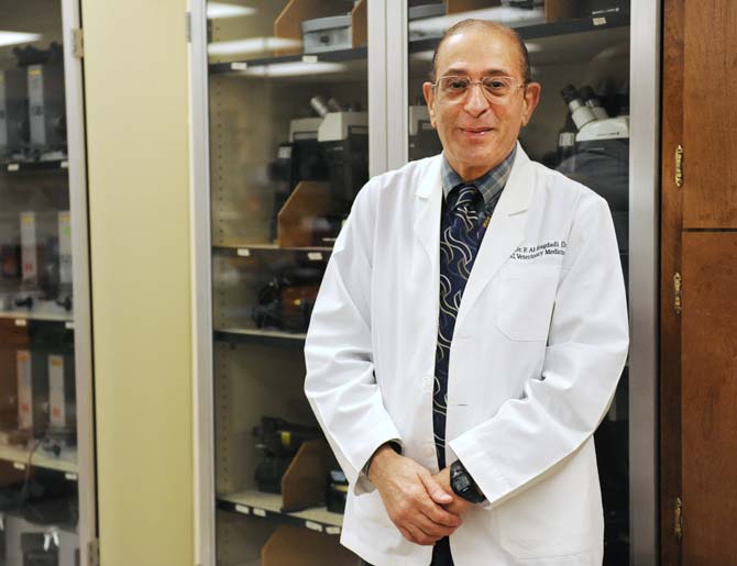 Dr. Fakhri Kareem Al-Bagdadi, LSU School of Veterinary Medicine associate professor, stands in front of microscopes April 29, 2013, in a laboratory at the school. Al-Bagdadi has been a professor at the University for nearly 40 years.
 