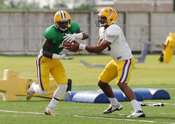 LSU freshman quarterback Anthony Jennings (10) hands the ball off to senior running back Alfred Blue (4) April 11, 2013 during practice at the LSU Football Operations Center.