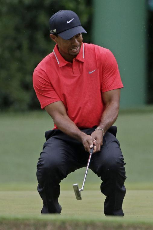 Tiger Woods reacts after missing a putt on the fourth green during the fourth round of the Masters golf tournament Sunday, April 14, 2013, in Augusta, Ga. (AP Photo/Darron Cummings)
 