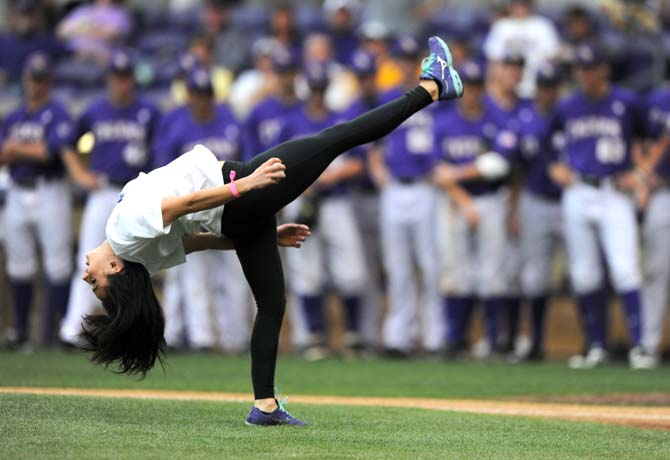 LSU sophomore gymnast and 2013 SEC Gymnast of the Year Rheagan Courville performs a front flip as part of her opening pitch Saturday, April 27, 2013 before the Tigers' 4-2 loss to South Carolina in Alex Box Stadium.
 