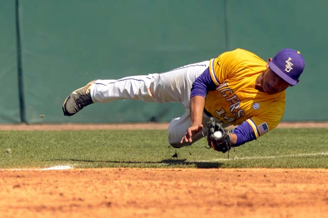 LSU third baseman Christian Ibarra falls to the ground while tracking a wild pop up for the out against Alabama during their NCAA college baseball game, Sunday, April 21, 2013, in Tuscaloosa, Ala. Alabama won 4-3 in the 10th inning. (AP Photo/Alabama Media Group, Vasha Hunt) MAGS OUT
 