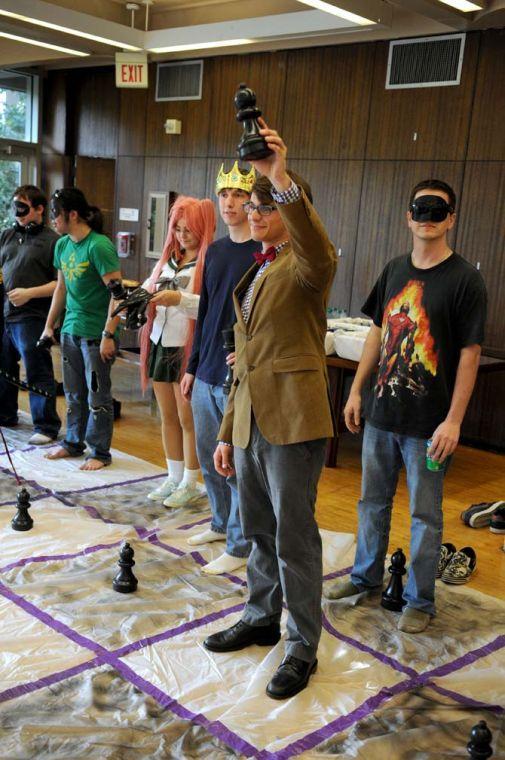 Chemistry sophomore Alex Rueff holds up a pawn before a game of "Wizard's Chess," during which the players step onto a life-sized chess board and play as the pieces. He was the coordinator of the event and was dressed as the Doctor from "Doctor Who."
 