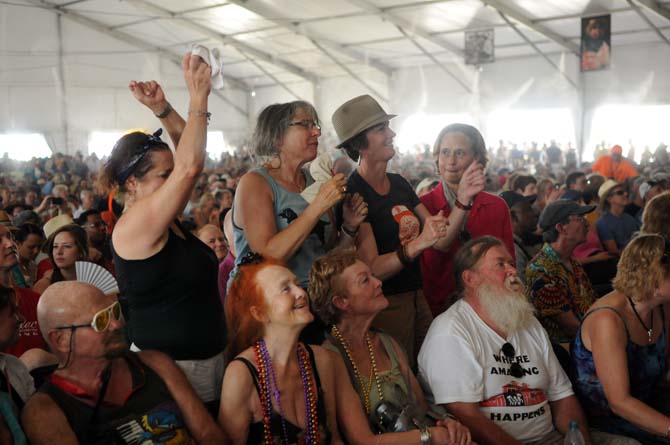 Audience members dance as Lil' Buck Sinegal's Blues Band performs Saturday, April 27, 2013 at the New Orleans Jazz &amp; Heritage Festival on the Fair Grounds Race Course.
 