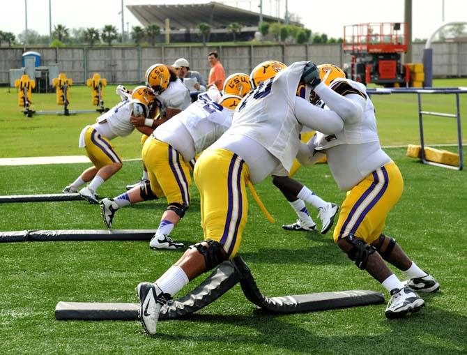 Members of the LSU Football team collide during a practice play Tuesday, April 16, 2013.
 