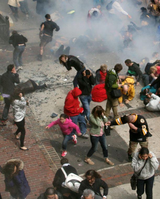 FILE - In this Monday, April 15, 2013 file photo provided by Ben Thorndike, people react to an explosion at the 2013 Boston Marathon in Boston. Since Monday, Boston has experienced five days of fear, beginning with the marathon bombing attack, an intense manhunt and much uncertainty ending in the death of one suspect and the capture of the other. (AP Photo/Ben Thorndike, File)
 