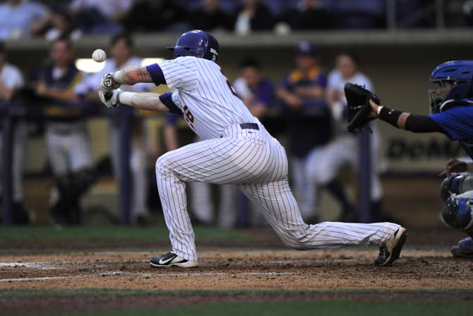 LSU junior catcher Ty Ross bunts the ball Tuesday, April 30, 2013, during the Tigers' 7-3 win against the MSU Cowboys.
 