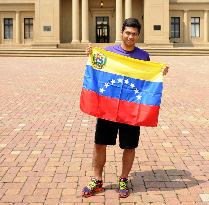 LSU Mechanical Engineering graduate student Gustavo Gonzalez holds a Venezuelan flag as he stands in protest in front of the Memorial Tower. "There were 400,000 more votes this election than the last one," he said. "There's something wrong with that number."
 