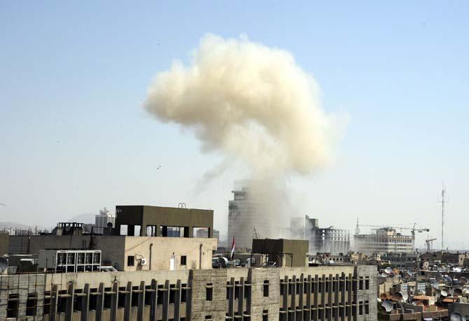 This photo released by the Syrian official news agency SANA, shows billowing smoke from a powerful explosion that shook Damascus in the central Marjeh district of Damascus, Syria, Tuesday, April. 30, 2013. State TV said the explosion caused casualties. The blast comes a day after the Syrian Prime Minister narrowly escaped an assassination attempt a heavily protected area of Damascus. (AP Photo/SANA)
 