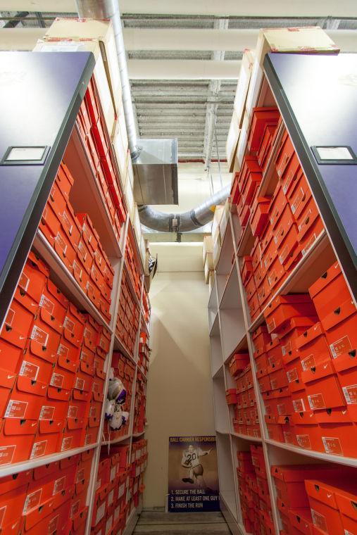 Stacks of Nike shoe boxes line the walls.
 