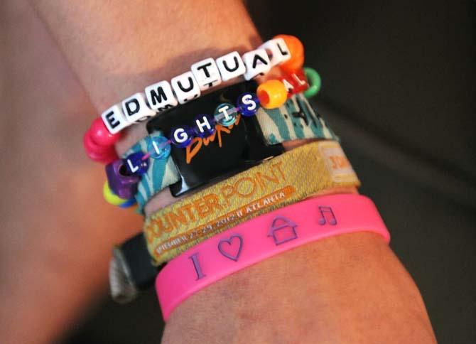 Computer engineering sophomore Cody Pitre shows off his "candy bracelets" and music festival wristbands April 15, 2013, at his apartment.
 