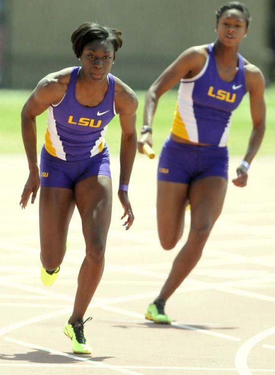 Senior Kimberlyn Duncan (left) sprints during the 4x100 meter relay as junior Jasmin Stowers runs up behind her Saturday, April 13, 2013.
 