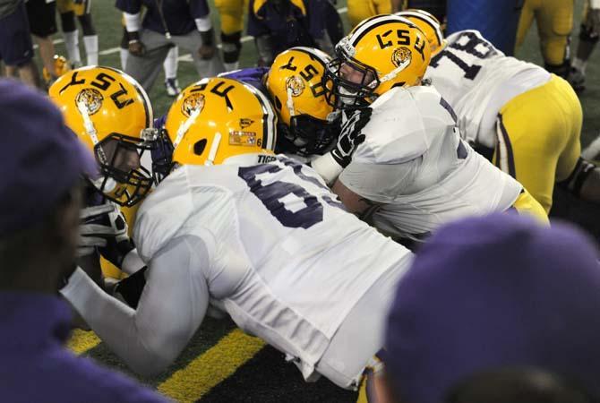 Members of the LSU Football team collide during a "big cat" drill Tuesday, April 16, 2013.
 