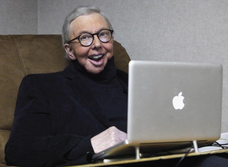 FILE - In this Jan. 12, 2011 file photo, Pulitzer Prize-winning movie critic Roger Ebert works in his office at the WTTW-TV studios in Chicago. Ebert died on Thursday, April 4, 2013. He was 70. Ebert started out as an old-school newspaper man, the kind that has all but vanished: a fierce competitor who spent the day trying to scoop the competition and the night bellied up to the bar swapping stories. Then newspapers fell on hard times, either laying off huge chunks of their staffs or disappearing altogether. But Ebert didn't merely survive. He flourished, largely by embracing television and later the Internet and social networks. (AP Photo/Charles Rex Arbogast, File)
 